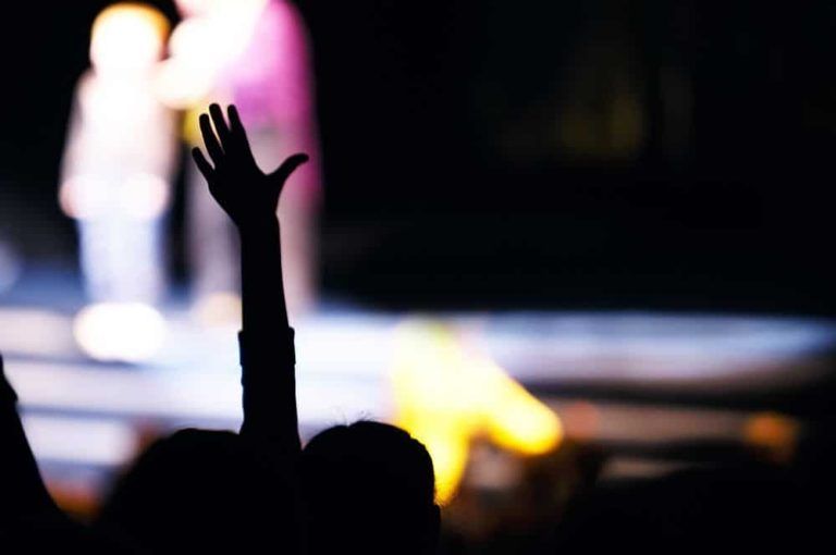 supporter-in-the-audience-raising-a-hand-2022-02-09-23-01-14-utc.jpg